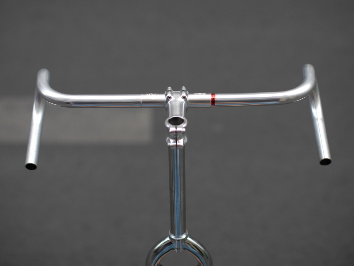 CRUMB x NITTO Futen Drop handlebar front view in flat bar orientation, showing the wide 540mm span and subtle upsweep at the hood position