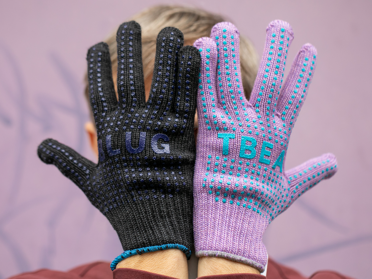 Blue Lug x Tembea merino wool gloves in black and lavender, anti-slip dots and colourway contrast on display