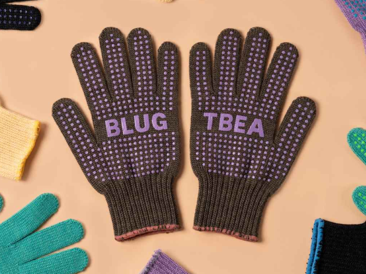 Blue Lug x Tembea merino wool gloves in brown with purple anti-slip dots, flat lay showing both palms