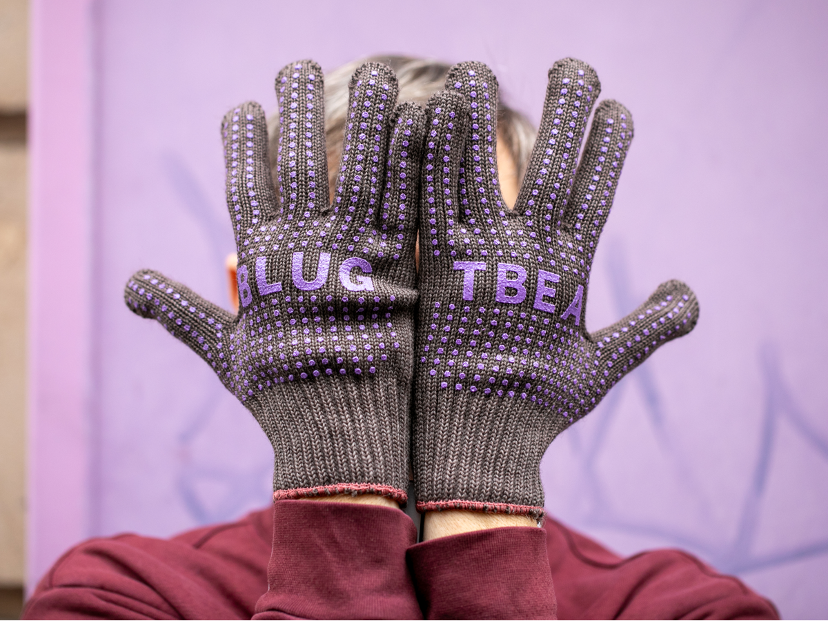 Blue Lug x Tembea merino wool gloves in brown with purple branding and anti-slip dots