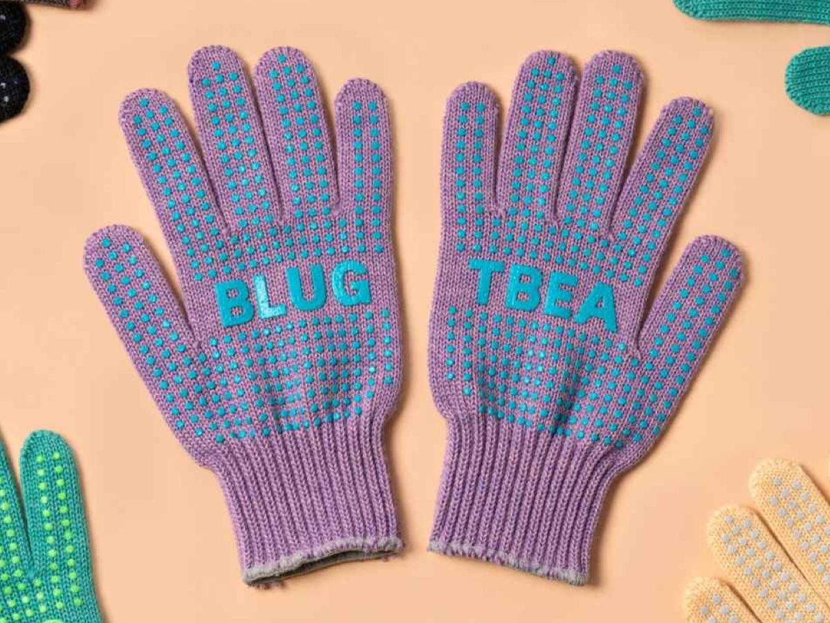 Blue Lug x Tembea merino wool gloves in lavender with teal anti-slip dots, flat lay showing both palms