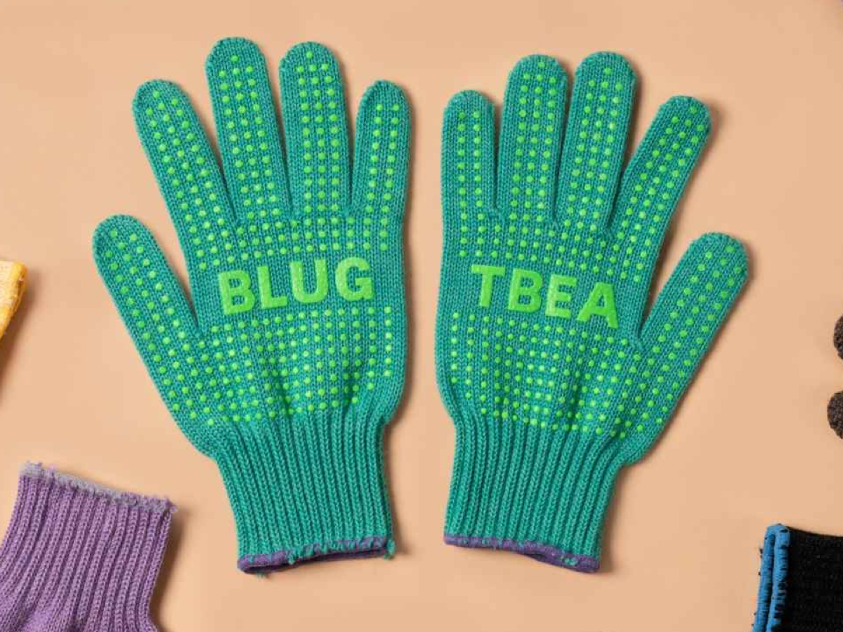 Blue Lug x Tembea merino wool gloves in teal with lime green anti-slip dots, flat lay showing both palms